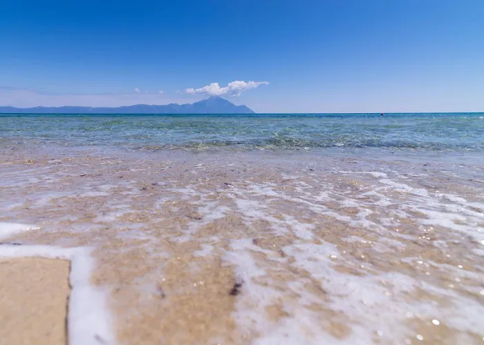 Calm Greek pebble beach with sun lounger near Sykia