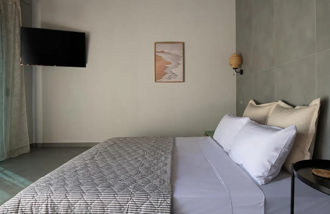 Second bedroom with TV and natural light